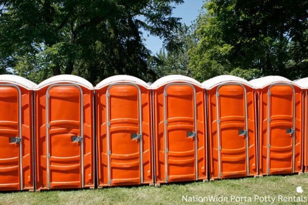 a lineup of clean and well-maintained portable loos for workers in Basin, WY